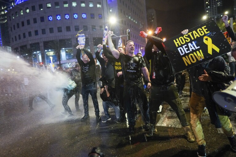 FILE - Police use water cannons to disperse demonstrators during a protest against Israeli Prime Minister Benjamin Netanyahu's government, and calling for the release of hostages held in the Gaza Strip by the Hamas militant group, in Tel Aviv, Israel on Feb. 24, 2024. (AP Photo/Ohad Zwigenberg, File)